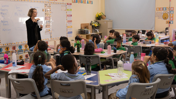 wellspring private school elementary teacher with classroom of students