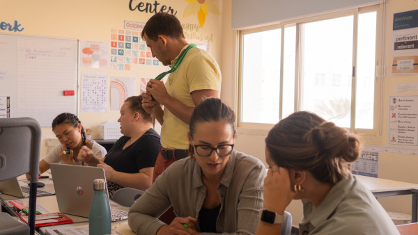 students learning about WellSpring Private School teachers as they go over their homework